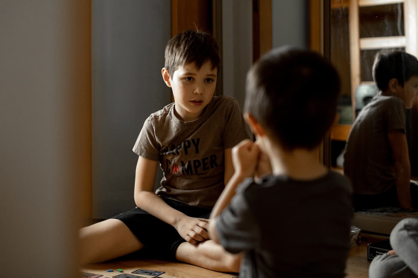 An image of two brothers playing a board game.
