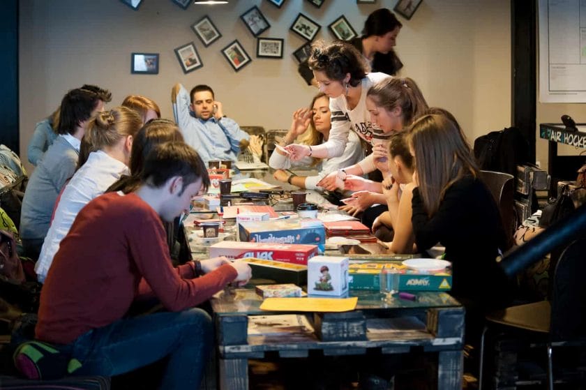 An image of an Unidentified young playing an Alias game in Moscow. This game is becoming more and more popular among young to relax in a cafe.