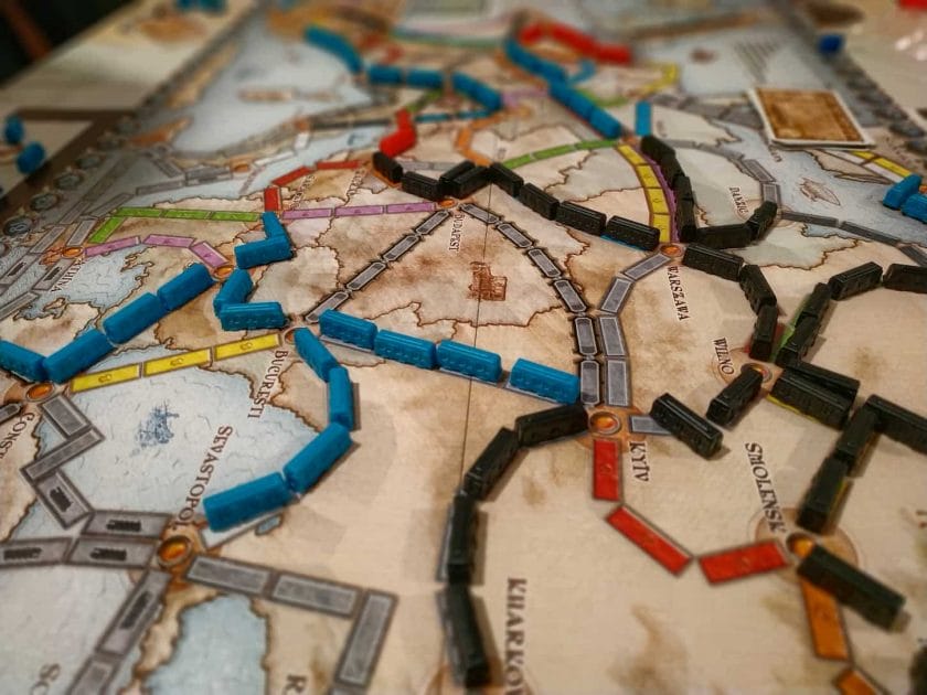 An image of a game at the board game Ticket to Ride: with a railway setting, players must achieve goals by building a railway network. 