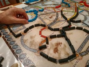 An image of A game at the board game Ticket to Ride: with a railway setting, players must achieve goals by building a railway network.