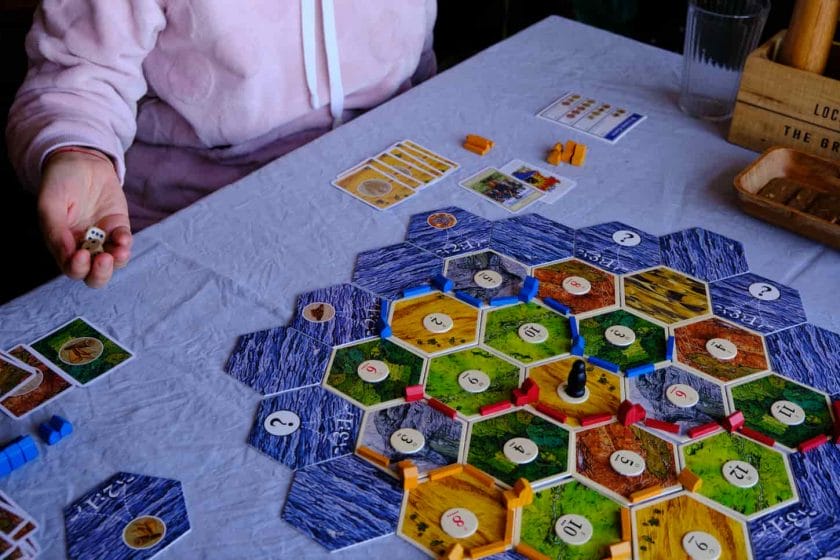 An image of Friends playing settlers of Catan board game, the concept for people playing board games.