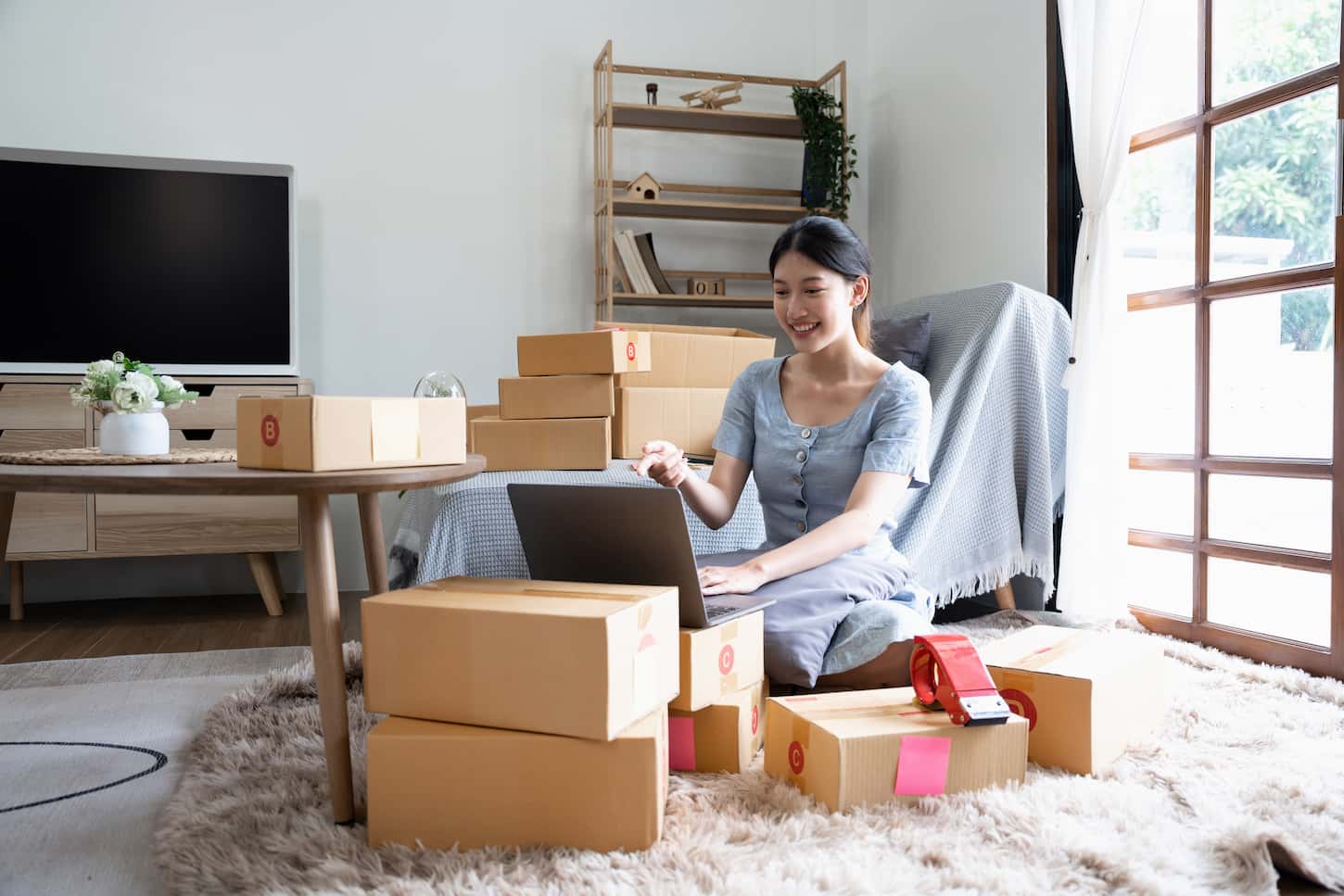 An image of an Asian business owners using laptop to communicate with customers via video calling. Online while working in the home office.