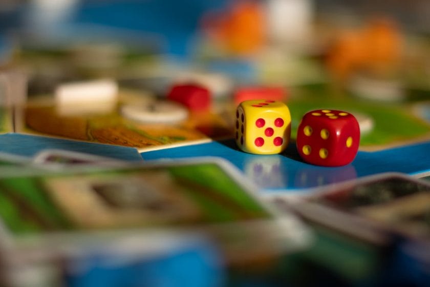 An image of 2 dice on top of a board game.