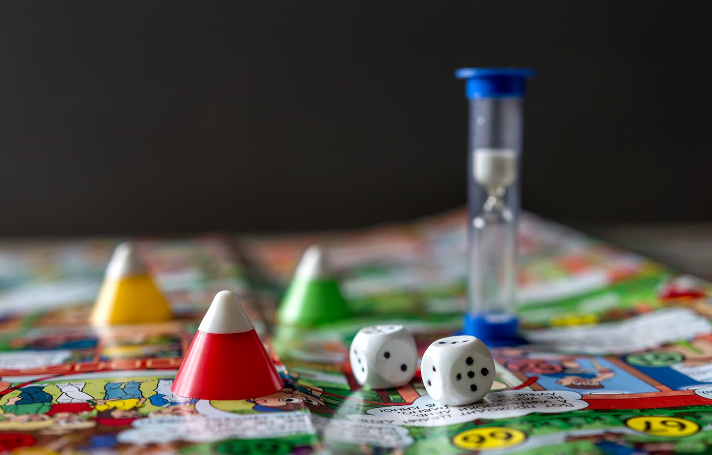 An image of Concept of board games. Dice, chips and cards on a yellow background.