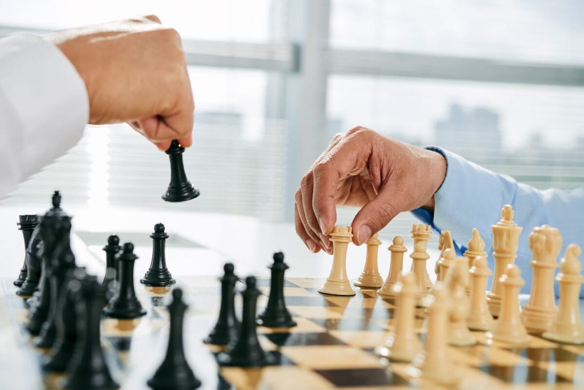 An image of men playing chess in selective focus.